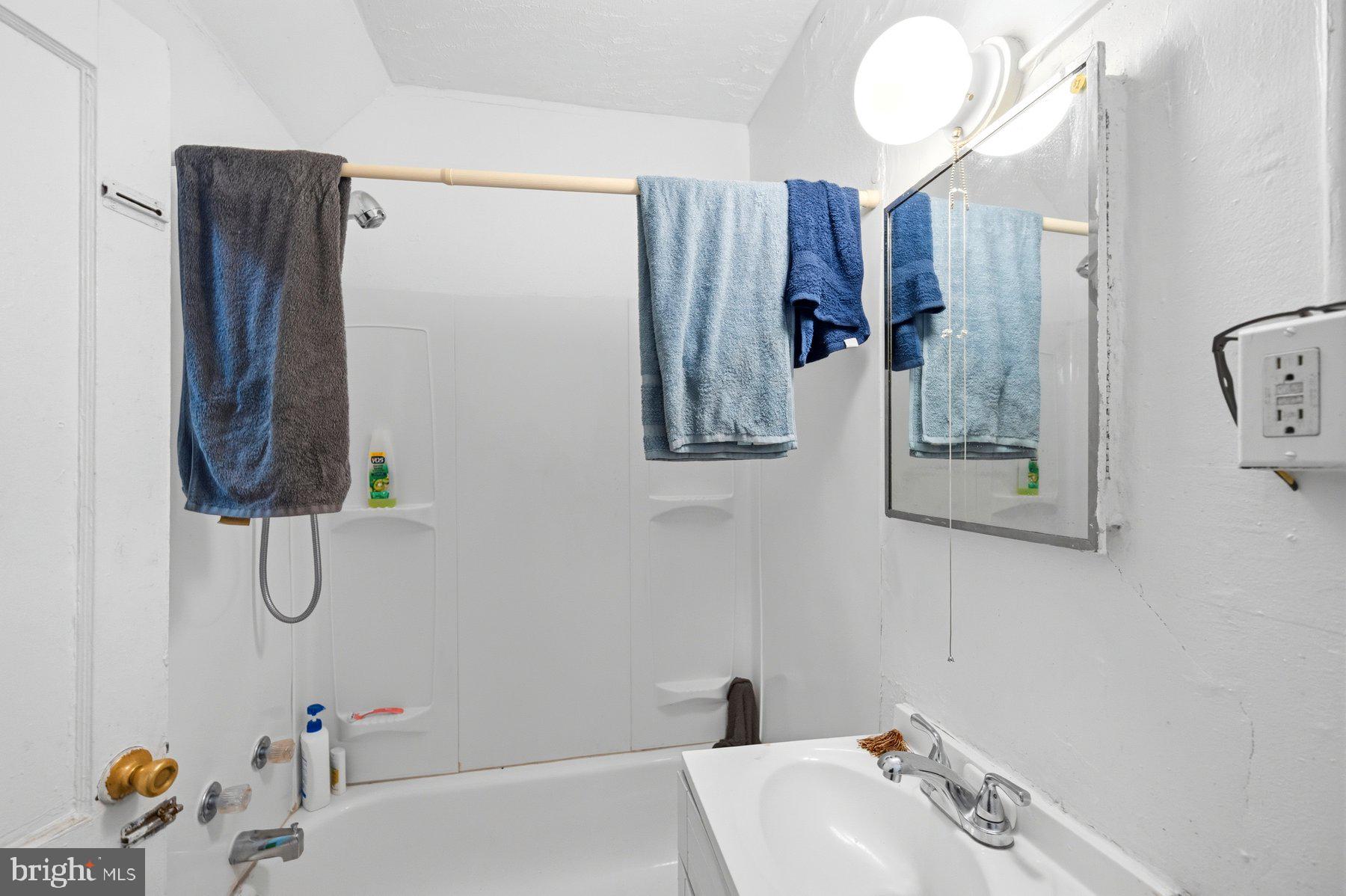 923 1st Street Baltimore, MD 21225 - Photo 14 of 32 a bathroom with a sink and mirror
