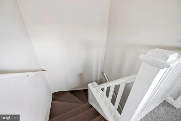 a view of a hallway with wooden floor and entryway