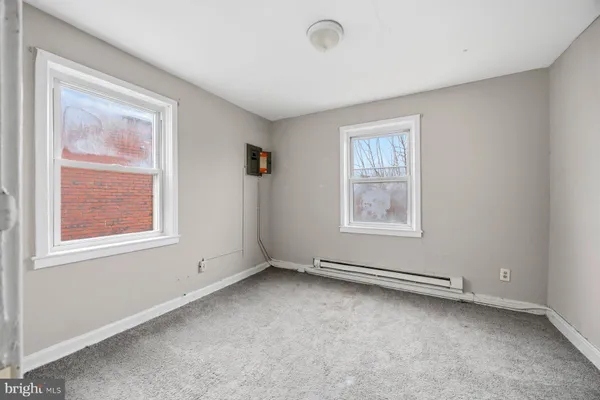 a view of room with window and wooden floor