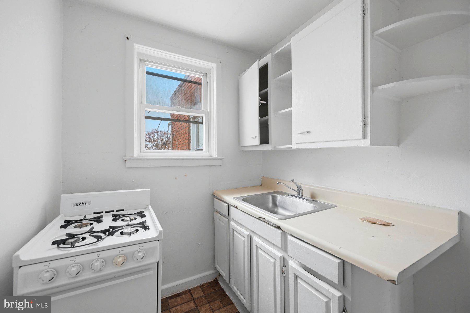 923 1st Street Baltimore, MD 21225 - Photo 29 of 32 a kitchen that has a sink and a stove