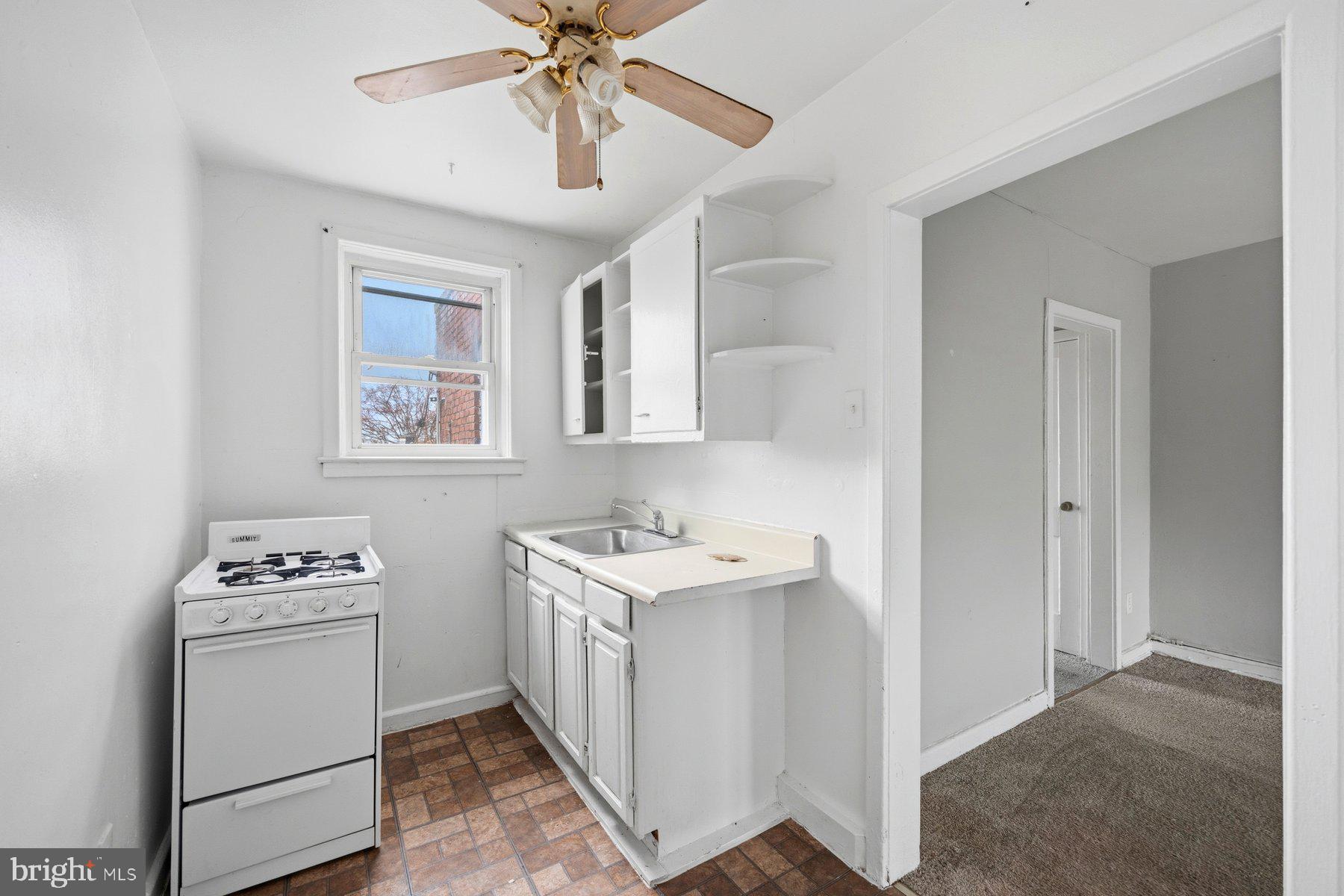923 1st Street Baltimore, MD 21225 - Photo 30 of 32 a utility room with cabinets washer and dryer