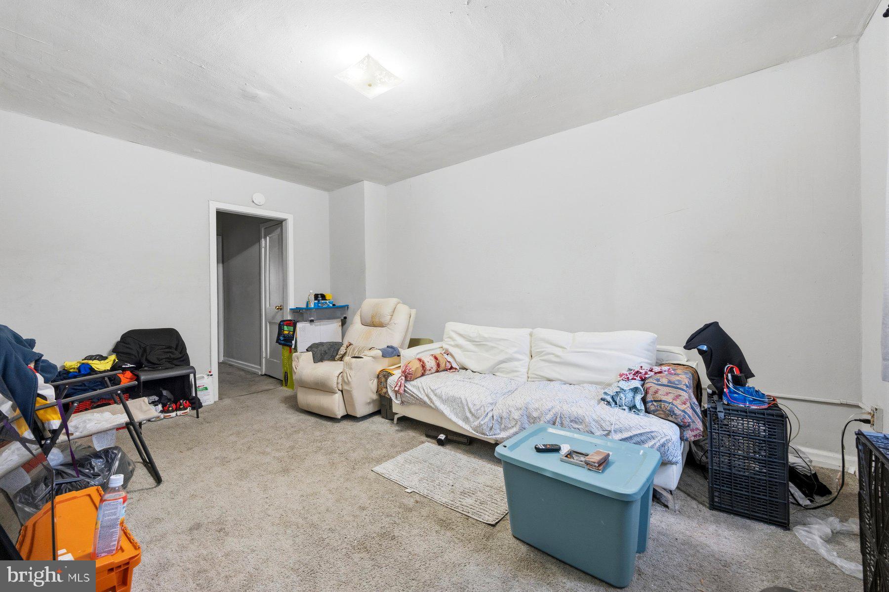 923 1st Street Baltimore, MD 21225 - Photo 3 of 32 a bedroom with furniture and a gym equipment
