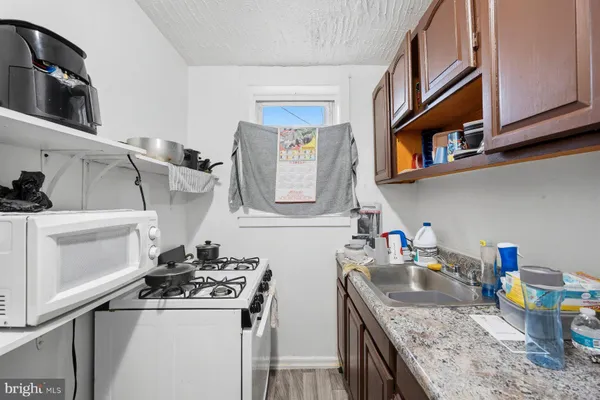 a kitchen with stainless steel appliances granite countertop a sink stove and cabinets