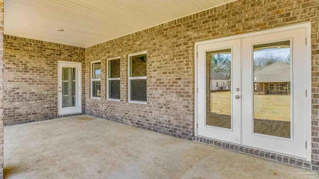 a view of a brick house with an outdoor space