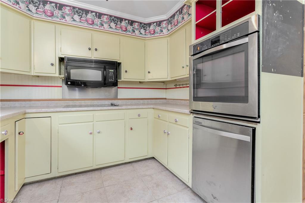 5306 Mockingbird Road Greensboro, NC 27406 - Photo 11 of 26 Cute, country kitchen with planter box window. Built-in oven and dishwasher. Smooth-top cooktop.