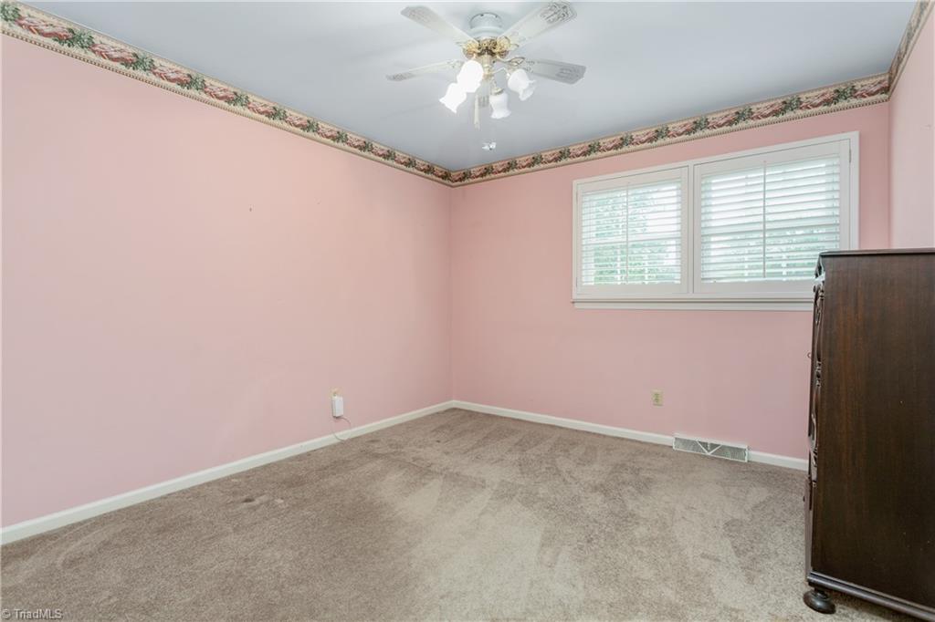 5306 Mockingbird Road Greensboro, NC 27406 - Photo 16 of 26 Bedroom #2. Plantation shutters in all upper level bedrooms. Hardwood floors appear to be under the carpet!