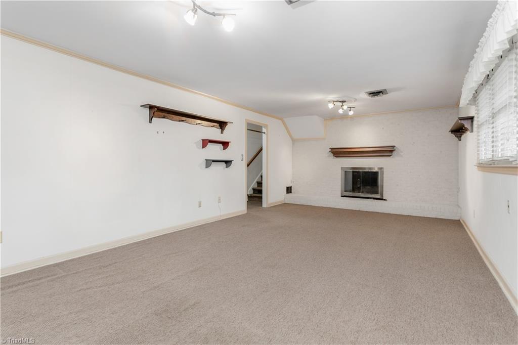 5306 Mockingbird Road Greensboro, NC 27406 - Photo 18 of 26 Virtually Staged lower level Den! The large room will accommodate the perfect Den, playroom, or recreation room!