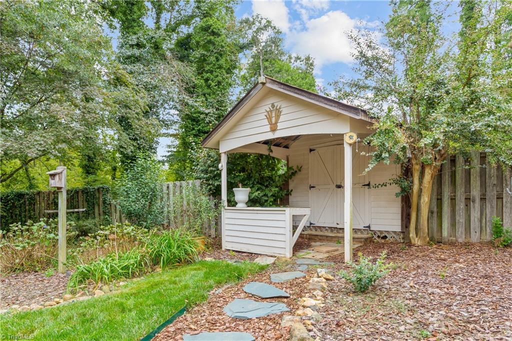 5306 Mockingbird Road Greensboro, NC 27406 - Photo 23 of 26 Deck is partially covered and overlooks the private backyard. Yard extends beyond the fence