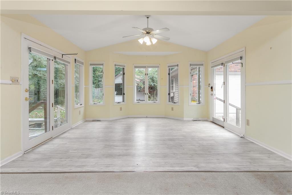 5306 Mockingbird Road Greensboro, NC 27406 - Photo 7 of 26 This open space allows for what your choose! Vinyl plank flooring, patio doors to deck and driveway/garage, ceiling fan and vaulted ceiling.