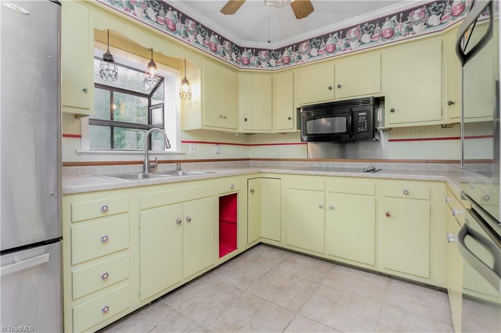 5306 Mockingbird Road Greensboro, NC 27406 - Photo 10 of 26 Great built-in storage with pull-out drawers and glass front cabinets for displaying your favorite collectables! Perfect spot for serving your guests we well!