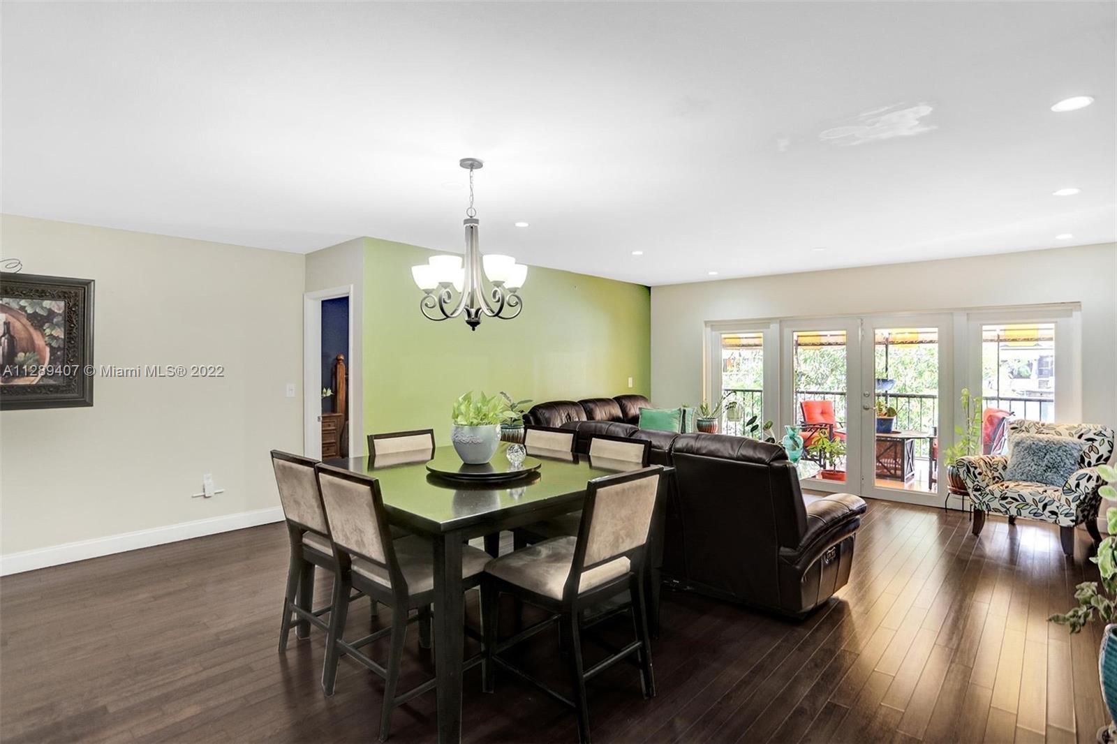 16511 Bridge End Road Miami Lakes, FL 33014 - Photo 14 of 43 a view of a dining room with furniture window and wooden floor