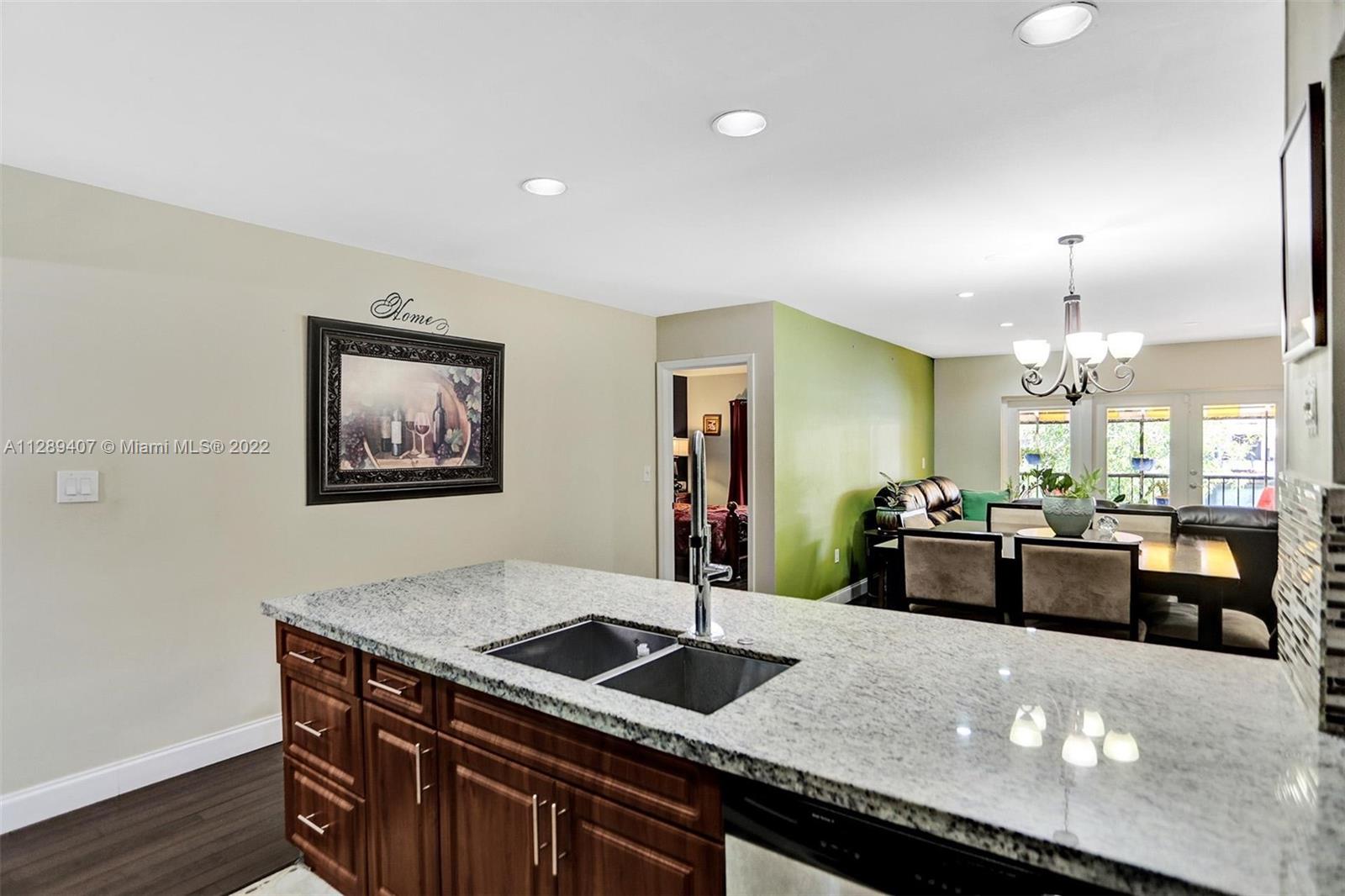 16511 Bridge End Road Miami Lakes, FL 33014 - Photo 19 of 43 a kitchen with granite countertop a stove and a refrigerator