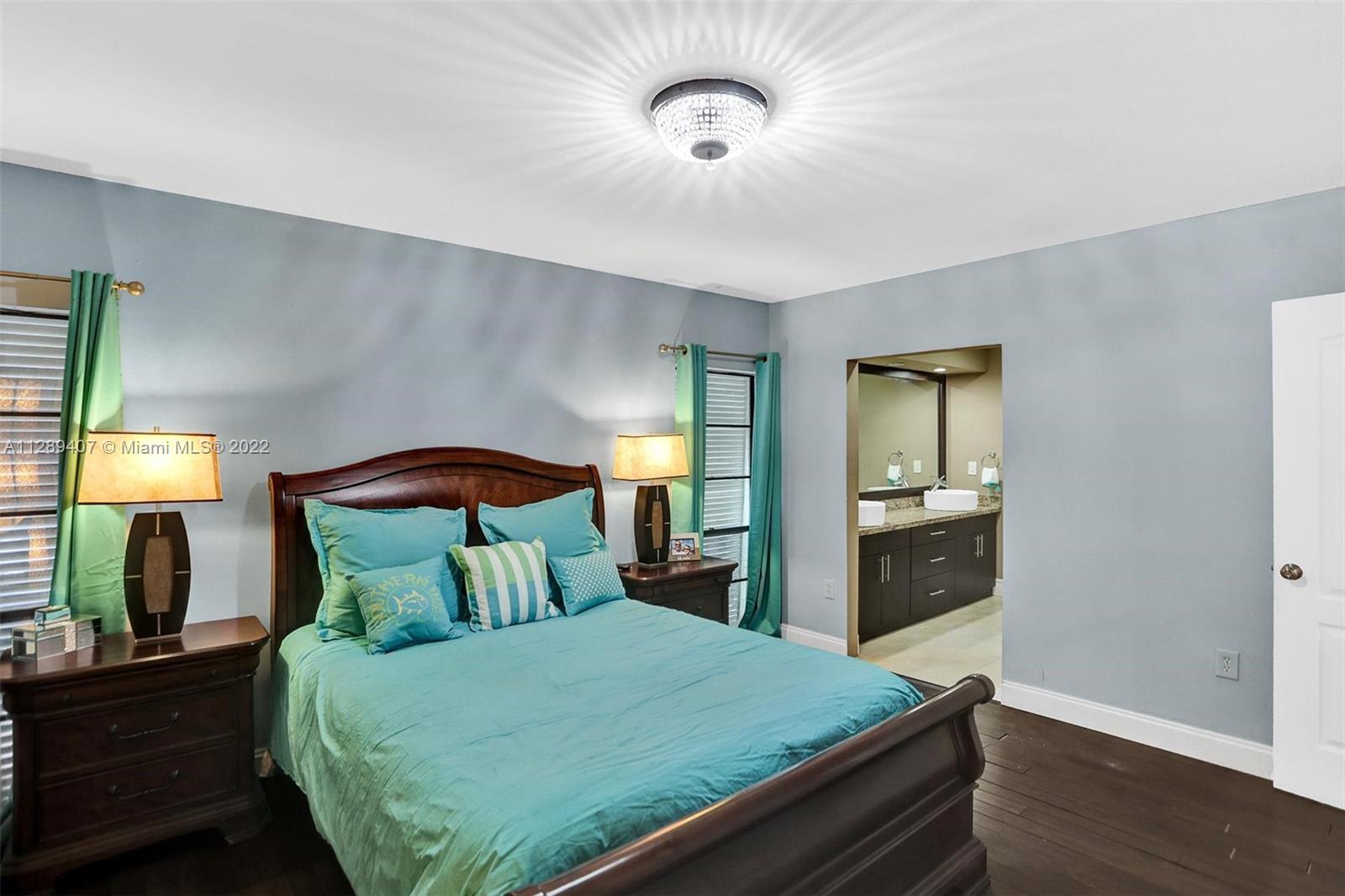 16511 Bridge End Road Miami Lakes, FL 33014 - Photo 21 of 43 a bedroom with a bed and a lamp