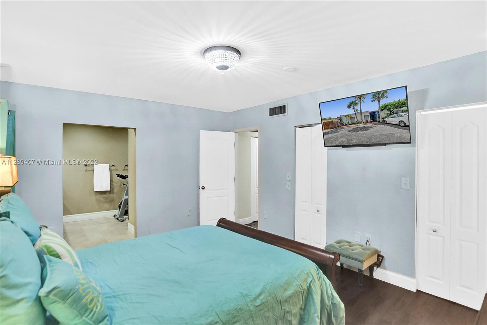 16511 Bridge End Road Miami Lakes, FL 33014 - Photo 25 of 43 a bedroom with a bed and a large mirror