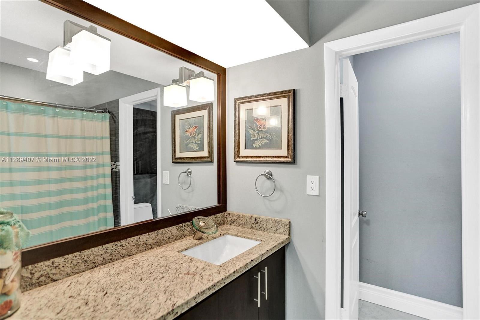 16511 Bridge End Road Miami Lakes, FL 33014 - Photo 28 of 43 a bathroom with a granite countertop sink and a mirror