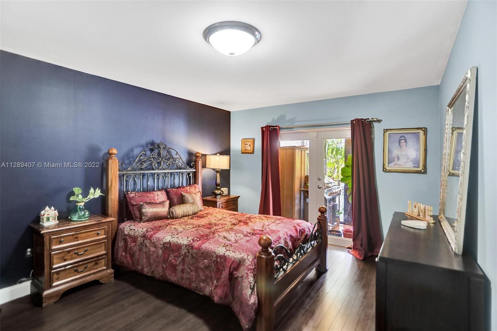 16511 Bridge End Road Miami Lakes, FL 33014 - Photo 30 of 43 a bedroom with a bed and wooden floor