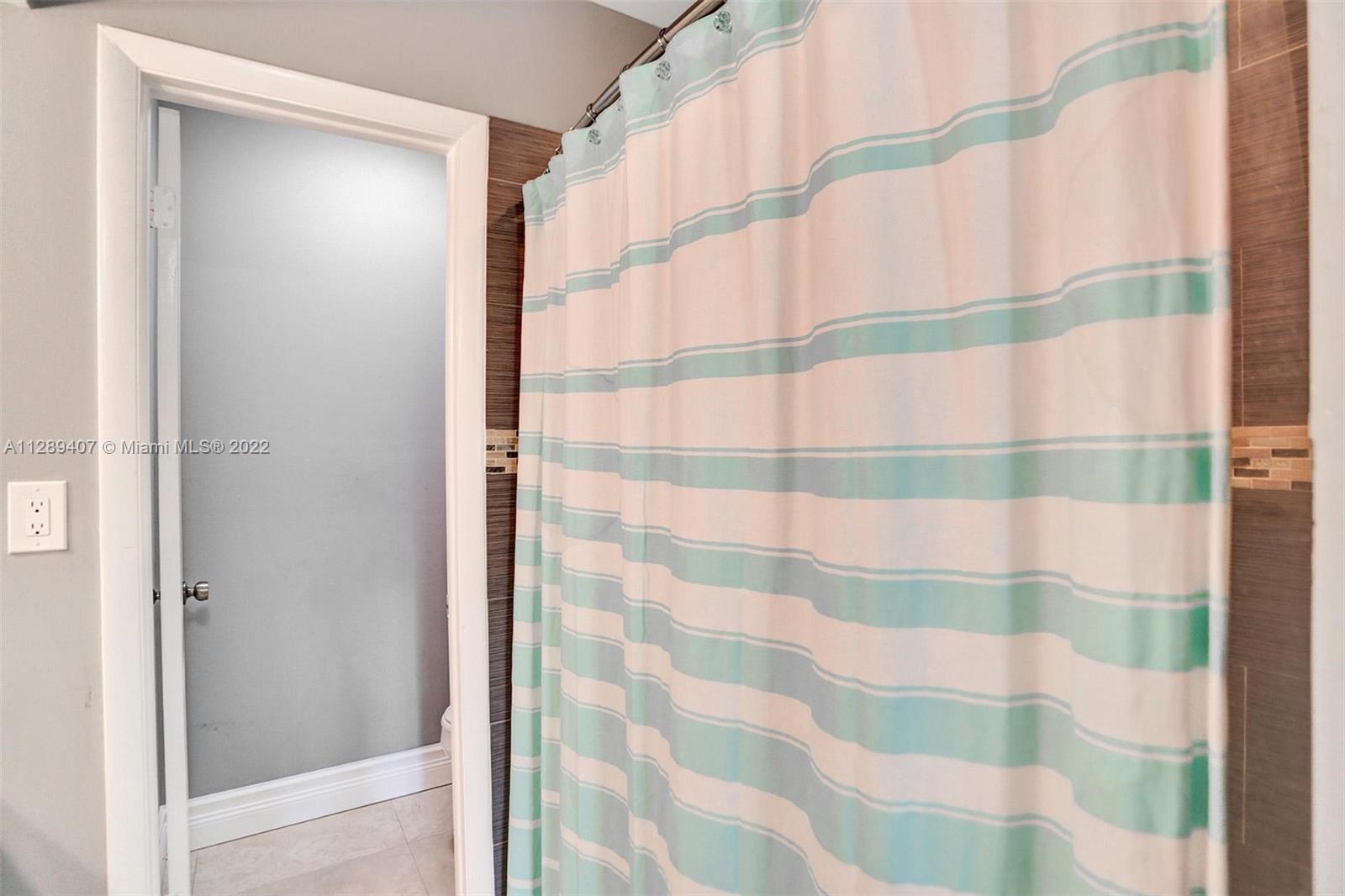 16511 Bridge End Road Miami Lakes, FL 33014 - Photo 34 of 43 a bathroom with a shower and a sink