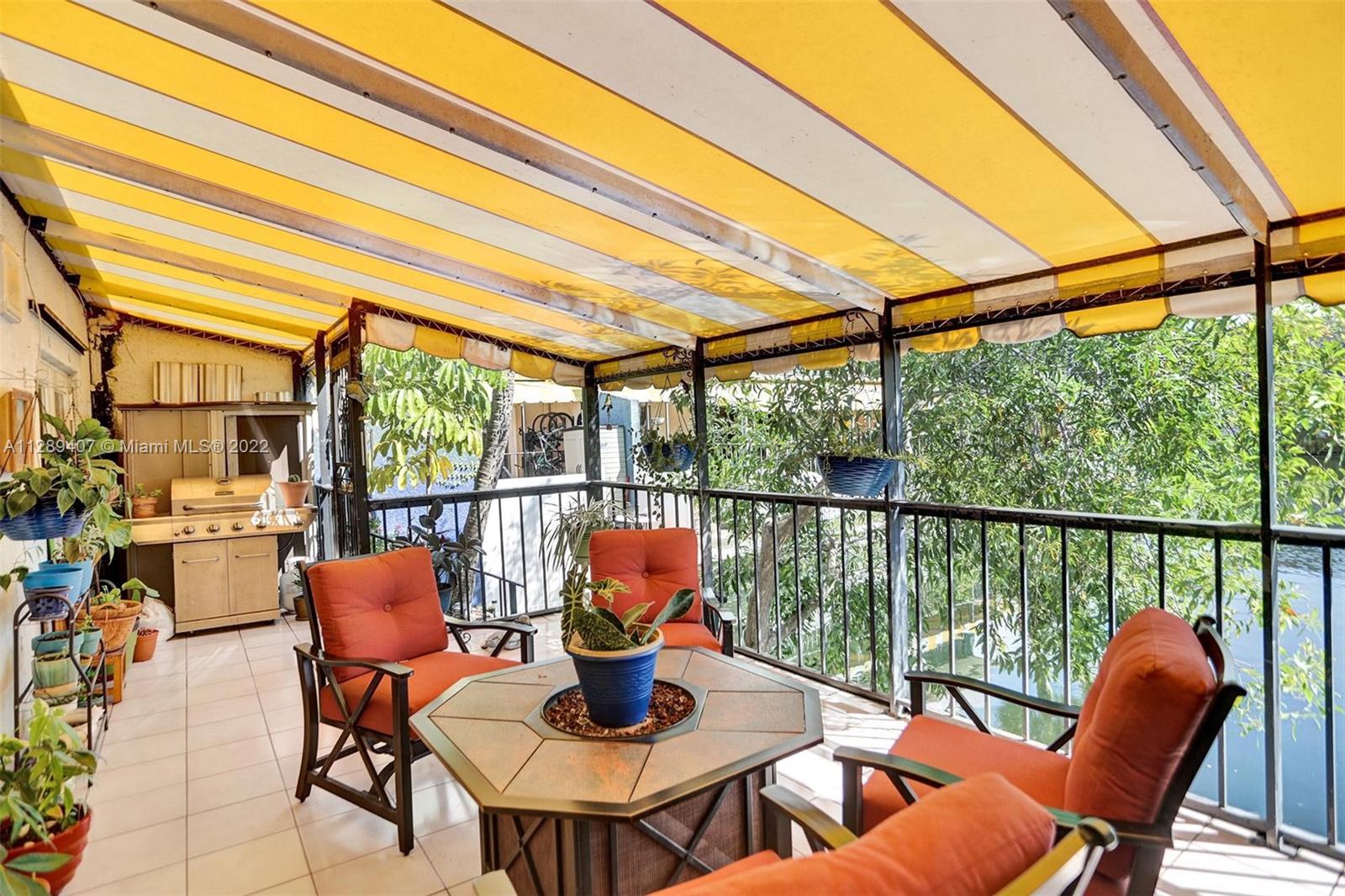 16511 Bridge End Road Miami Lakes, FL 33014 - Photo 36 of 43 a dining room with furniture and a floor to ceiling window