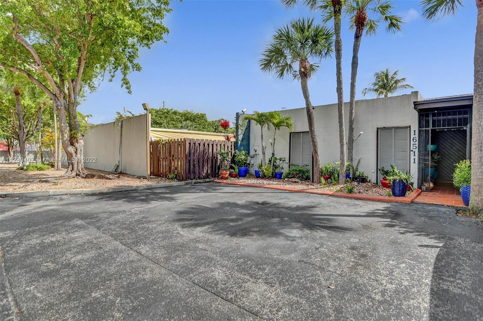 16511 Bridge End Road Miami Lakes, FL 33014 - Photo 4 of 43 a view of a street with a building in the background