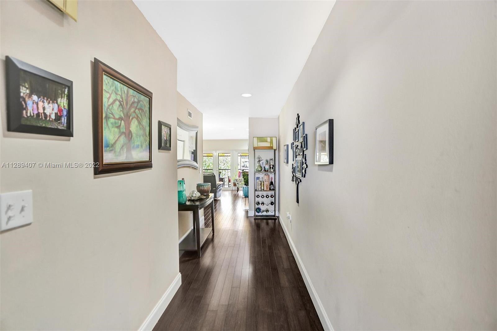 16511 Bridge End Road Miami Lakes, FL 33014 - Photo 6 of 43 a view of a hallway with wooden floor and stairs