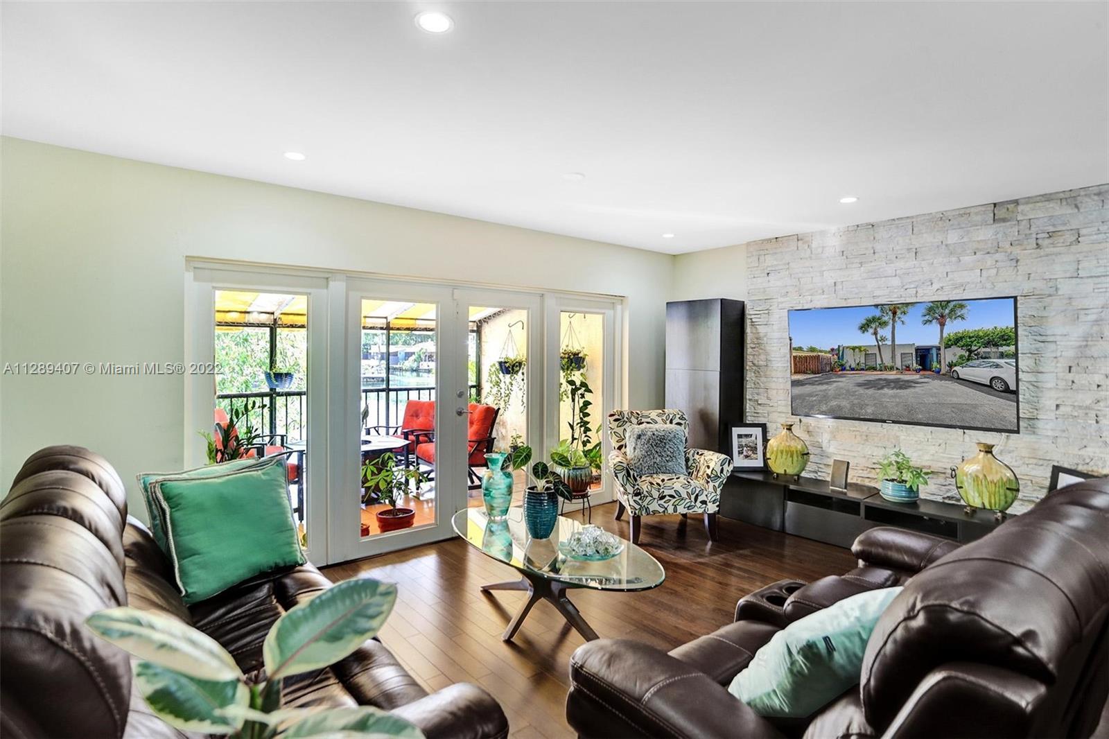 16511 Bridge End Road Miami Lakes, FL 33014 - Photo 9 of 43 a living room with furniture and a floor to ceiling window