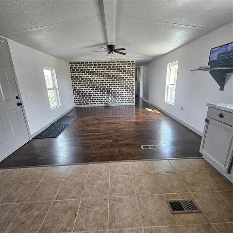 a view of livingroom with hardwood floor and window in a room