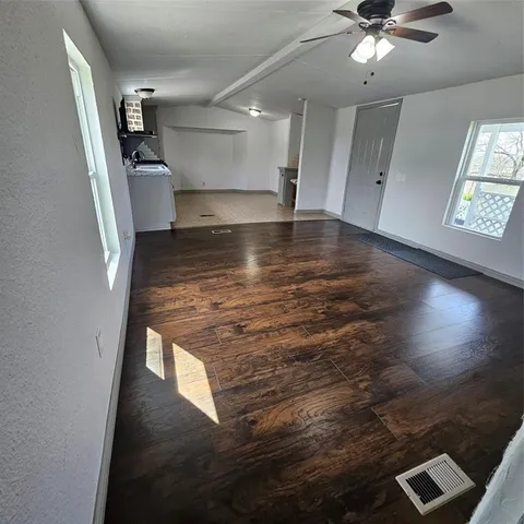 a view of a room with wooden floor