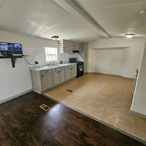 a kitchen with a sink and cabinets