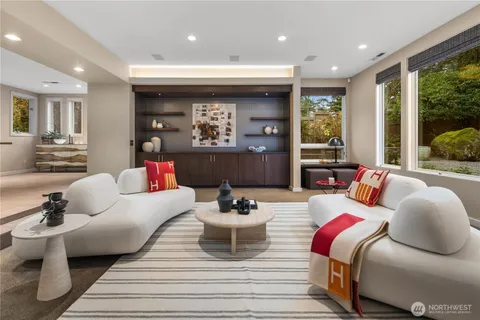 a living room with furniture and a view of kitchen