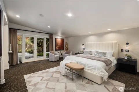 a living room with furniture and a view of kitchen