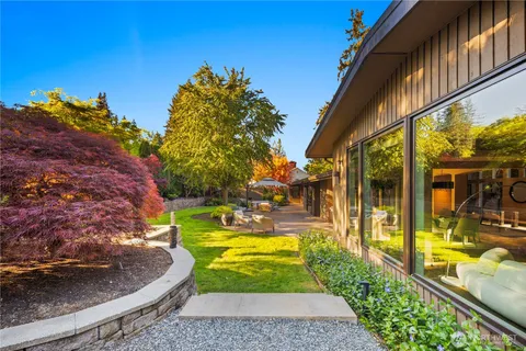 a view of a backyard with plants and patio
