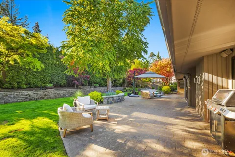 a view of backyard with outdoor seating and trees