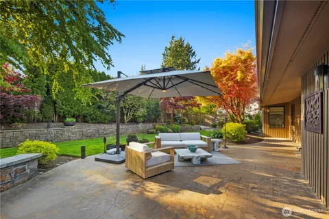 a view of a house with a big yard and large trees