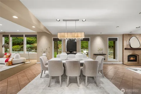 a view of a dining room with furniture a chandelier and wooden floor