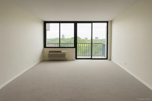 an empty room with large windows