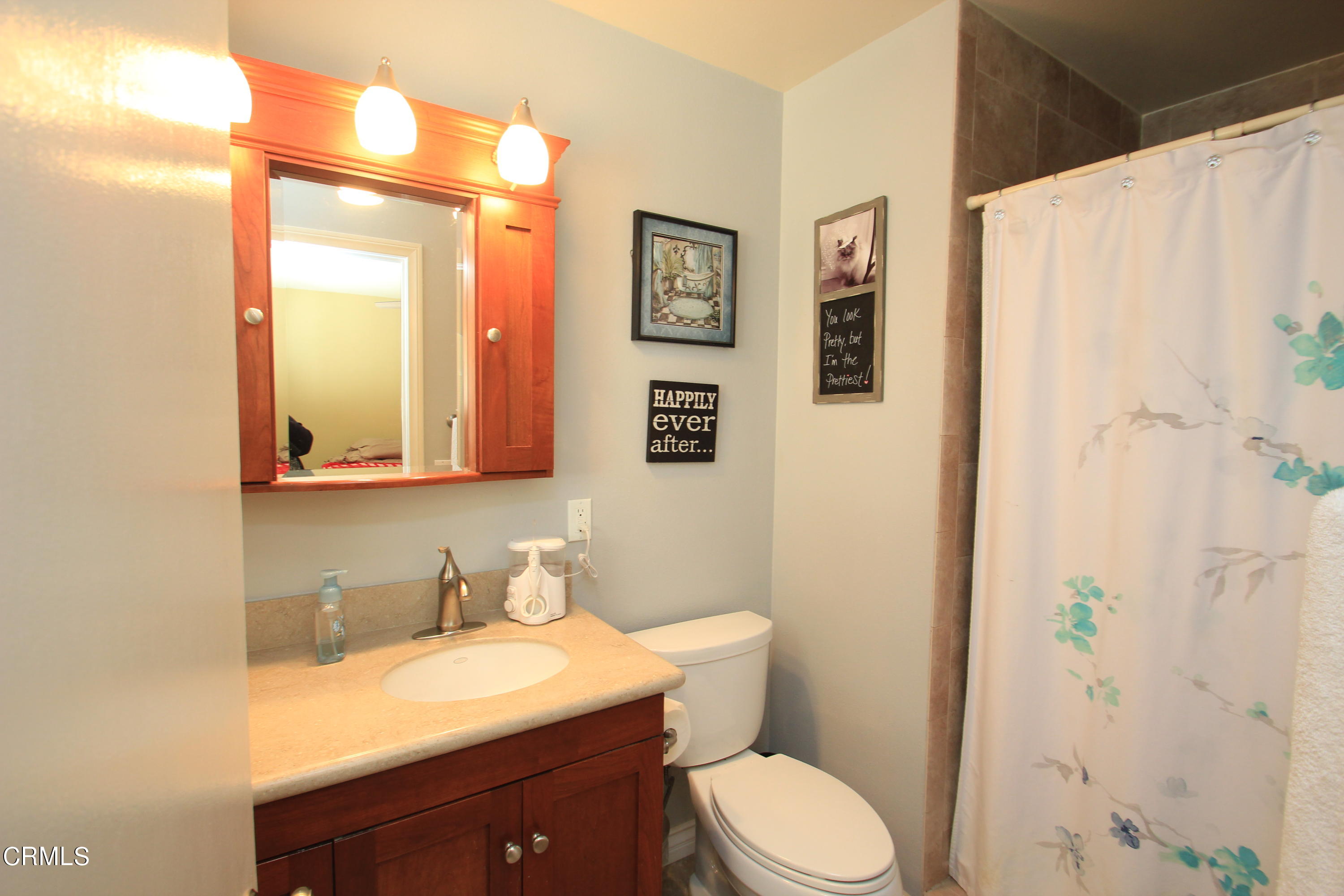 4221 Olds Road Oxnard, CA 93033 - Photo 14 of 34 a bathroom with a granite countertop toilet sink and mirror