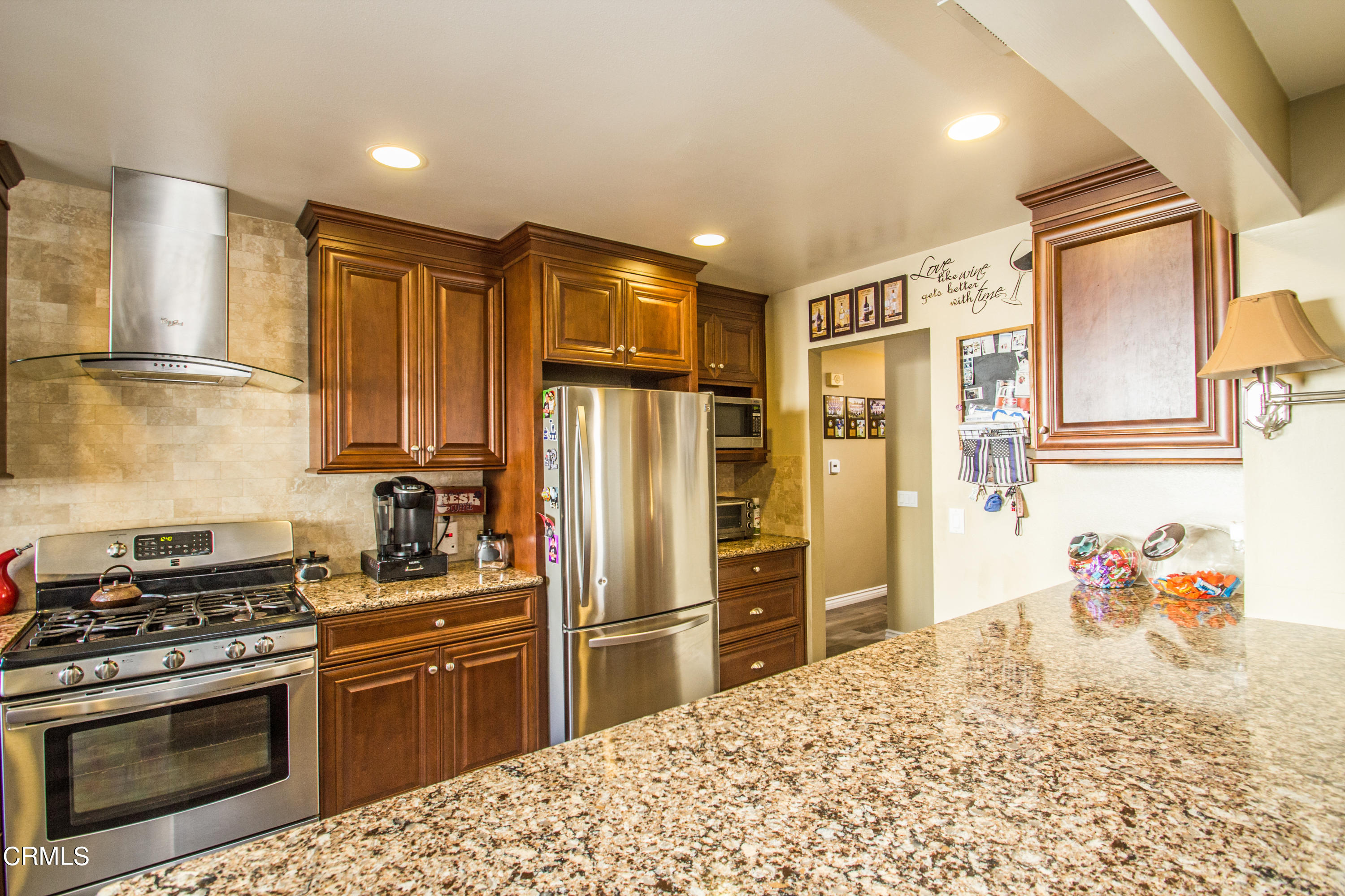 4221 Olds Road Oxnard, CA 93033 - Photo 21 of 34 a kitchen with stainless steel appliances kitchen island granite countertop a refrigerator stove and sink