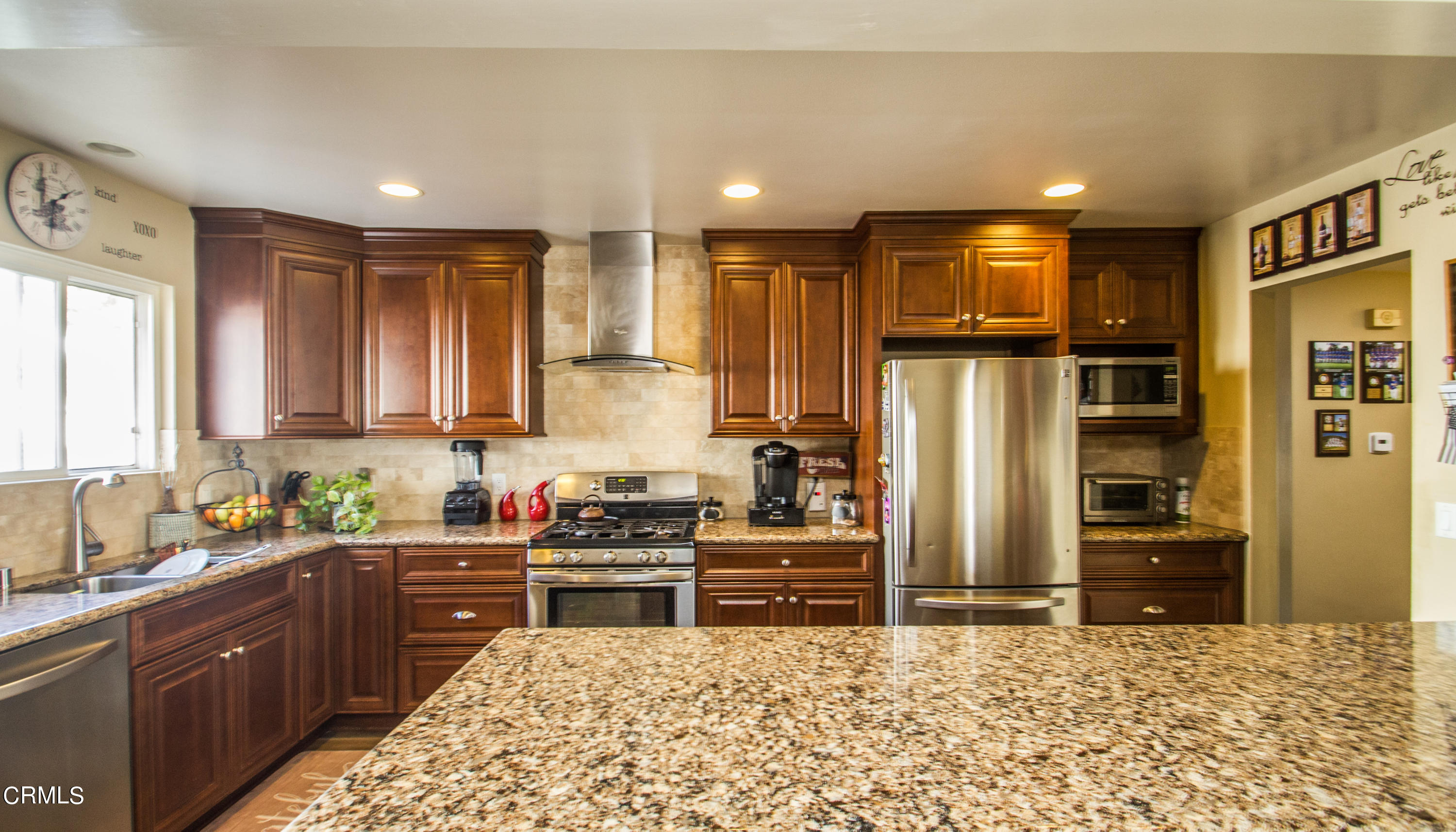 4221 Olds Road Oxnard, CA 93033 - Photo 5 of 34 a kitchen with stainless steel appliances kitchen island granite countertop a refrigerator and a sink