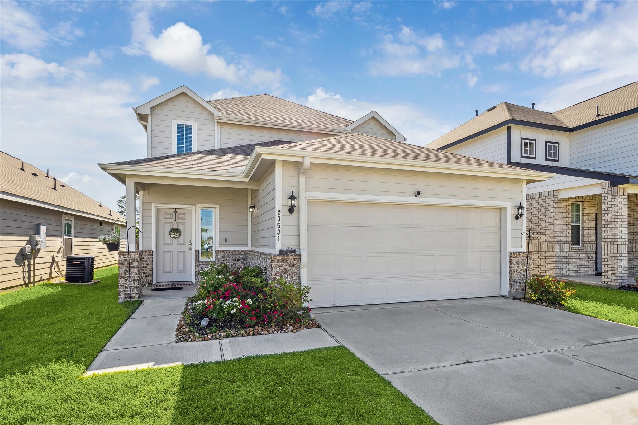 23531 Montague Drive Spring, TX 77373 - Photo 2 of 21 a view of a white house next to a yard and a large tree