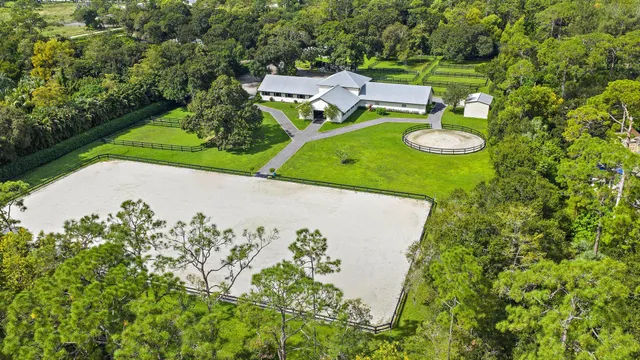 an aerial view of a house with a swimming pool