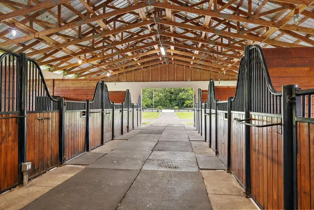 a view of staircase with railing and a chandelier