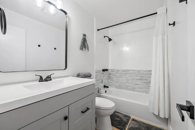 a bathroom with a shower and a sink