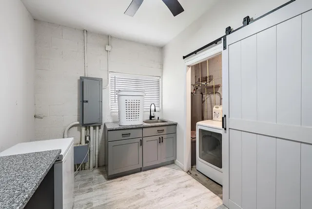 a kitchen with stainless steel appliances granite countertop a refrigerator stove sink and window