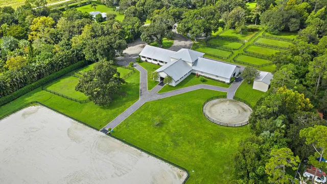 an aerial view of a house with outdoor space pool seating area and yard