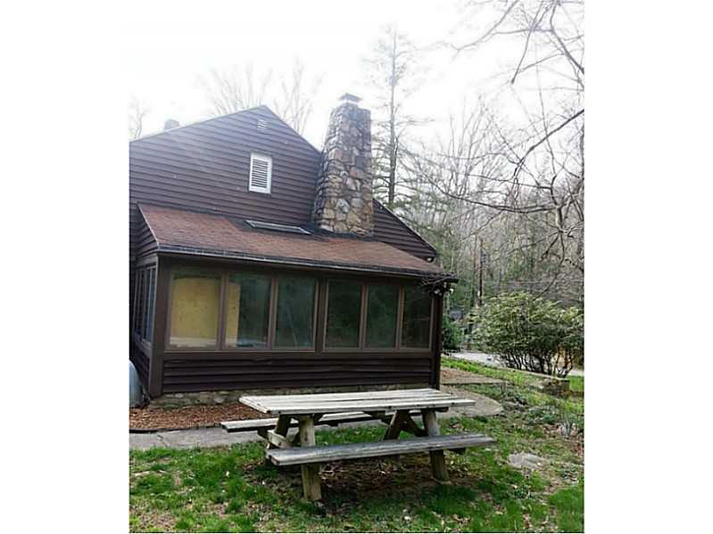 13 Hemlock Road Laughlintown, PA 15655 - Photo 3 of 22 Exterior Back. Three season room is lined with windows, offering an enclosed porch feeling.
