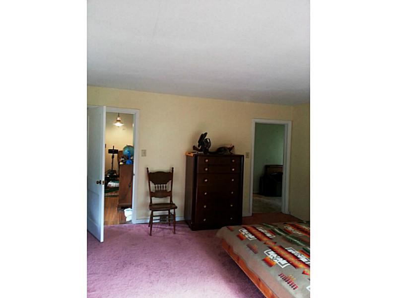 13 Hemlock Road Laughlintown, PA 15655 - Photo 21 of 22 Master Bedroom. Numerous entrances connect the master bedroom with the adjacent den or bedroom, as well as the laundry room.