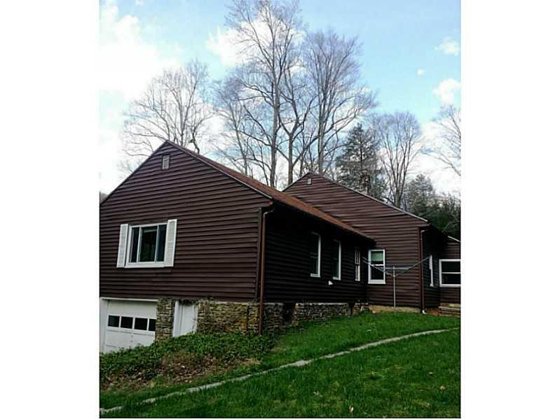 13 Hemlock Road Laughlintown, PA 15655 - Photo 5 of 22 Exterior Back. Stone foundation surrounds the home. A convenient driveway leads to a single car garage. But don t be deceived, this garage i quite large enough for a decent sized work/carpentry room or storage.