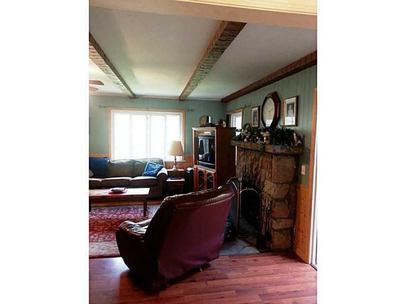 13 Hemlock Road Laughlintown, PA 15655 - Photo 8 of 22 Den/Family/Great Room. This is a wonderful living room with plenty of light and wood and a stone fireplace.