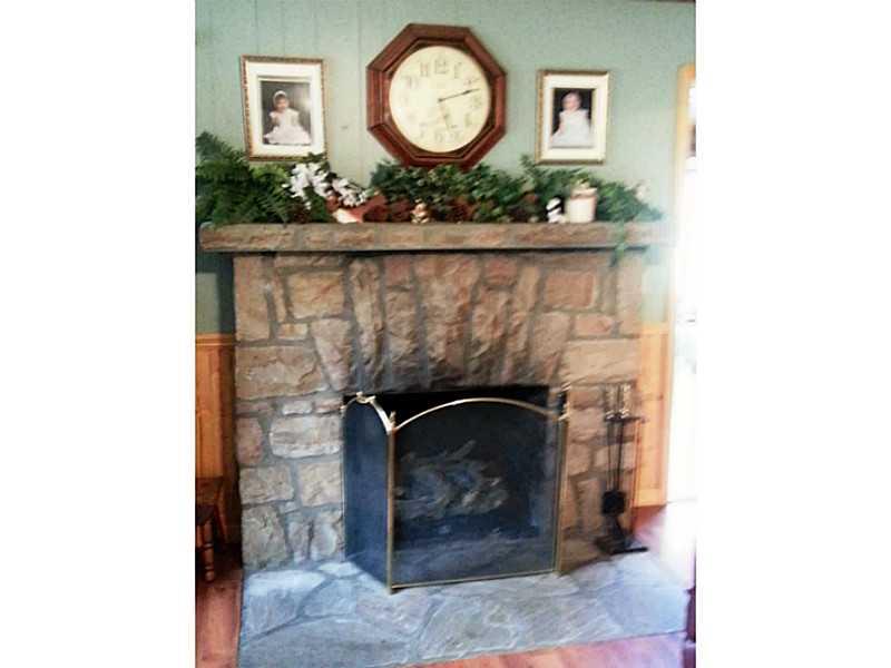 13 Hemlock Road Laughlintown, PA 15655 - Photo 9 of 22 Den/Family/Great Room. A beautiful stone fireplace is currently run by propane and heats the whole house. Easily converts back to wood burning.