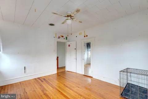 a room with pool table and windows